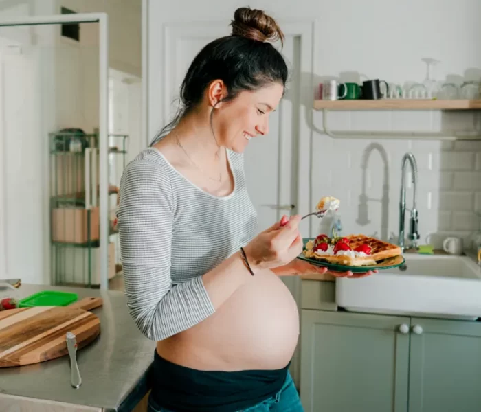 12 супер храни по време на бременност, II част - smiling future mother eating waffles 1296x728 header