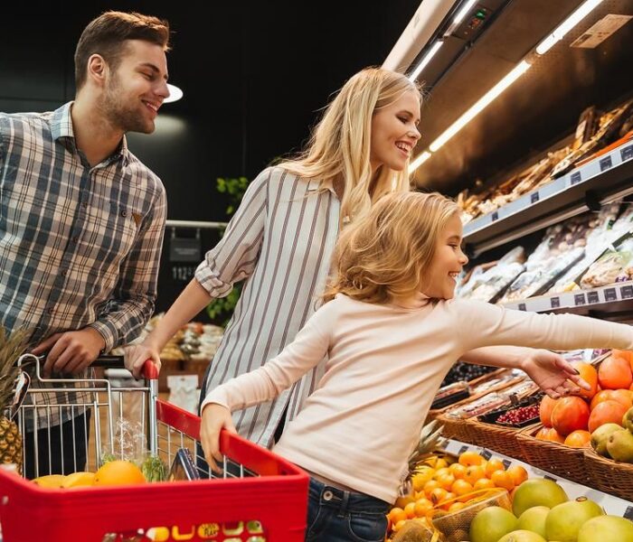 a family with a child shopping in a supermarket